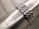 Close-up of the stainless steel bracelet wrapped around a wrist sizing mandrel, indicating a fit of approximately 175mm to 180mm.