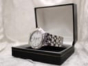 Raymond Weil Tango 5560 watch resting inside an open black presentation box with a white interior.