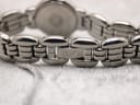 Close-up of the Raymond Weil stainless steel bracelet clasp, clearly showing the engraved 'RW' logo.