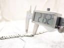 Close-up of a digital caliper accurately measuring the watch case diameter at 21.52mm.