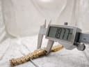 Digital caliper measuring the case diameter of the watch, displaying a precise reading of 18.77mm.
