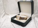 The Raymond Weil Tango watch presented inside a dark green watch box with a soft cream interior lining.