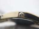 Extreme close-up of the original signed Tissot crown, clearly showing the 'T' logo.
