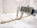 Digital caliper measuring the case diameter of the Tissot G349 watch, showing a precise reading of 23.25mm on the display.