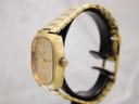 Right-side view of the gold-tone Talis watch, showing the crown and bracelet links on a display stand.