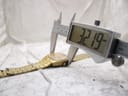 Digital caliper measuring the case diameter of the watch, displaying a precise measurement of '32.19' mm.