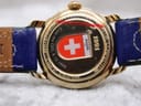 Close-up of the Michel Jordi Genève case back, showing "1991" and "8.12.1998" along with Swiss flag emblem and brown leather strap interior.