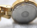 Close-up of the case back and lug area, showing 'STAINLESS STEEL' engraving and some wear where the bracelet joins the case.