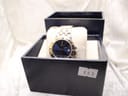 Raymond Weil Tango watch displayed in an open dark blue watch box on a textured surface, with a reference number '808' tag.