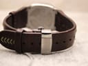 Rear view of the watch, showing the Lotus branded deployant clasp in its closed position, securing the brown leather strap.