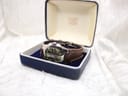 The Lotus 15509 watch resting inside a generic blue presentation box, positioned at an angle to display its dial and strap.