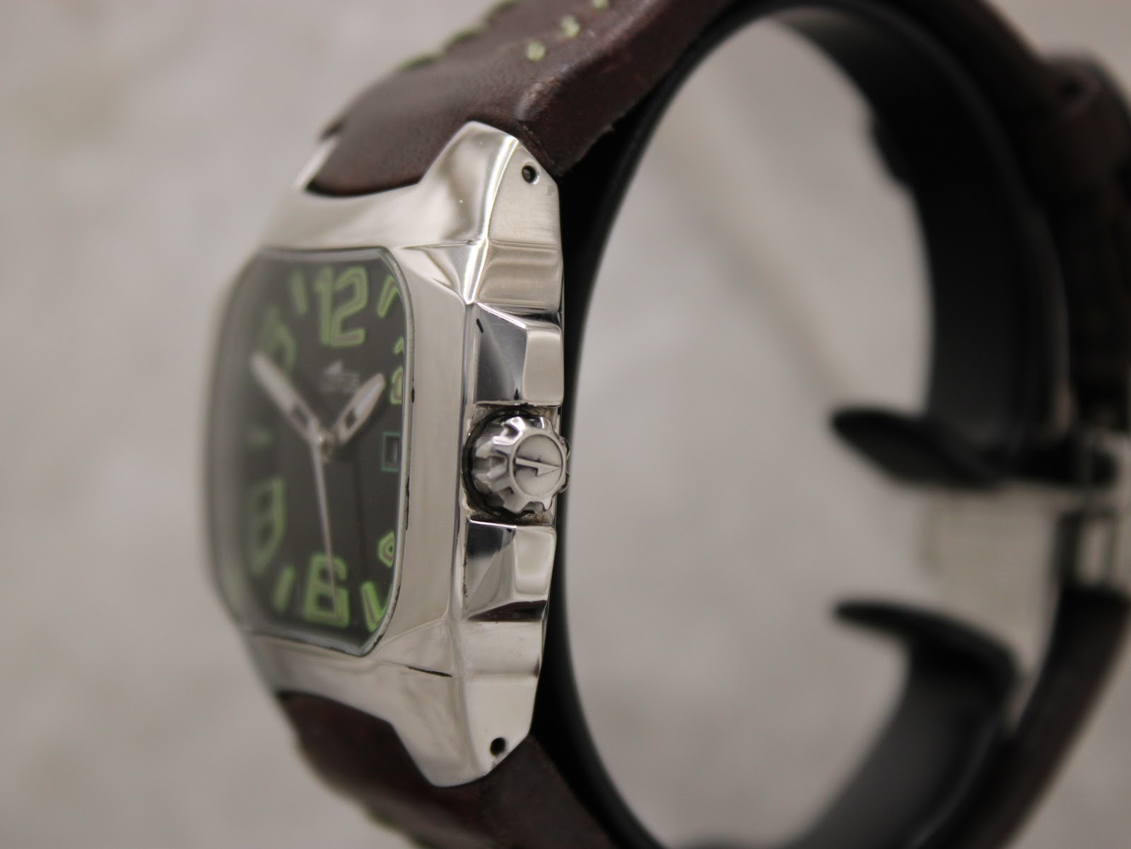 Side view of the Lotus 15509 stainless steel case from the right, showing the signed crown with the Lotus logo and the profile of the cushion-shaped case.