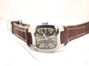 Angled top-down view of the Lotus 15509 watch, showing the full length of the brown leather strap with its distinctive green contrast stitching.