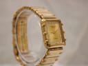 Another angled view of the gold Raymond Weil Coliseum watch, highlighting the side profile of the case.