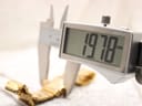 Close-up of a digital caliper measuring the watch case diameter at 19.78 mm.