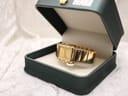 The Raymond Weil Coliseum watch resting inside a dark green presentation box.