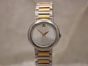 Front view of Movado Concerto ladies watch with silver dial and two-tone bracelet, on a white background.