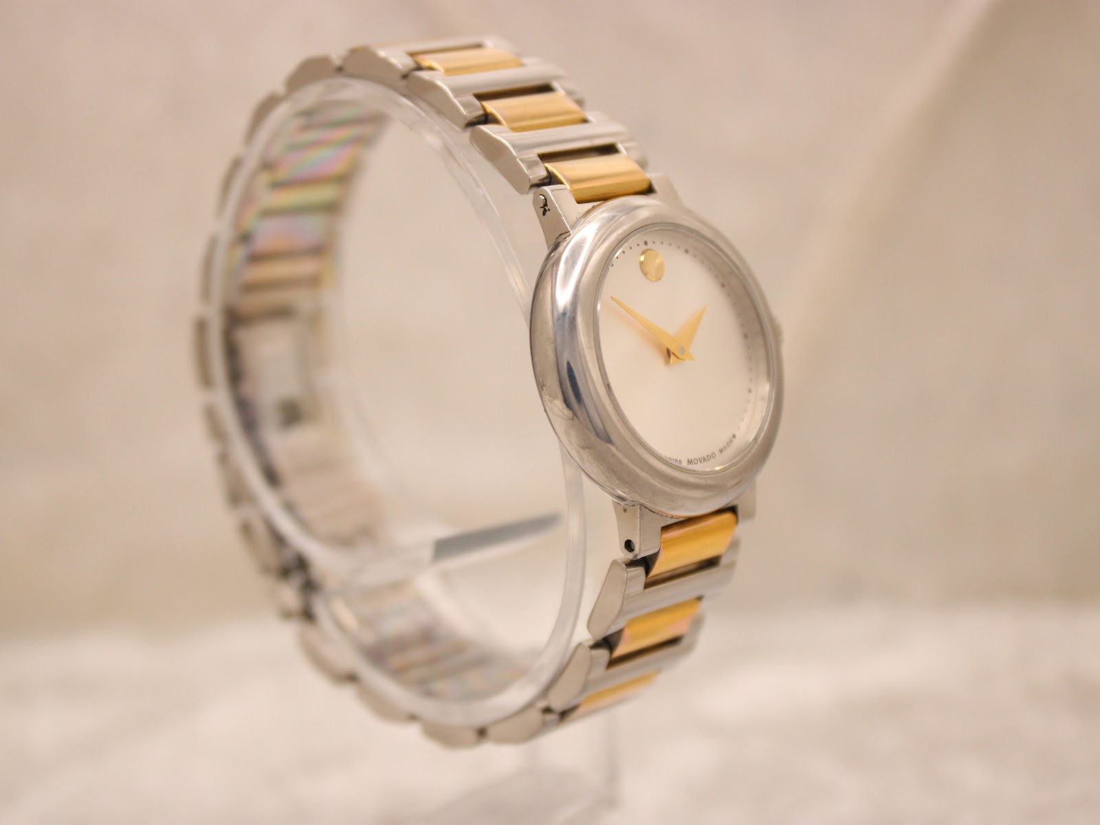 Angled side view of the Movado Concerto, emphasising the watch's elegant proportions and the contrast of the gold-tone links.