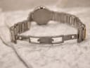 Detailed close-up of the Movado signed stainless steel fold-over clasp on the bracelet.