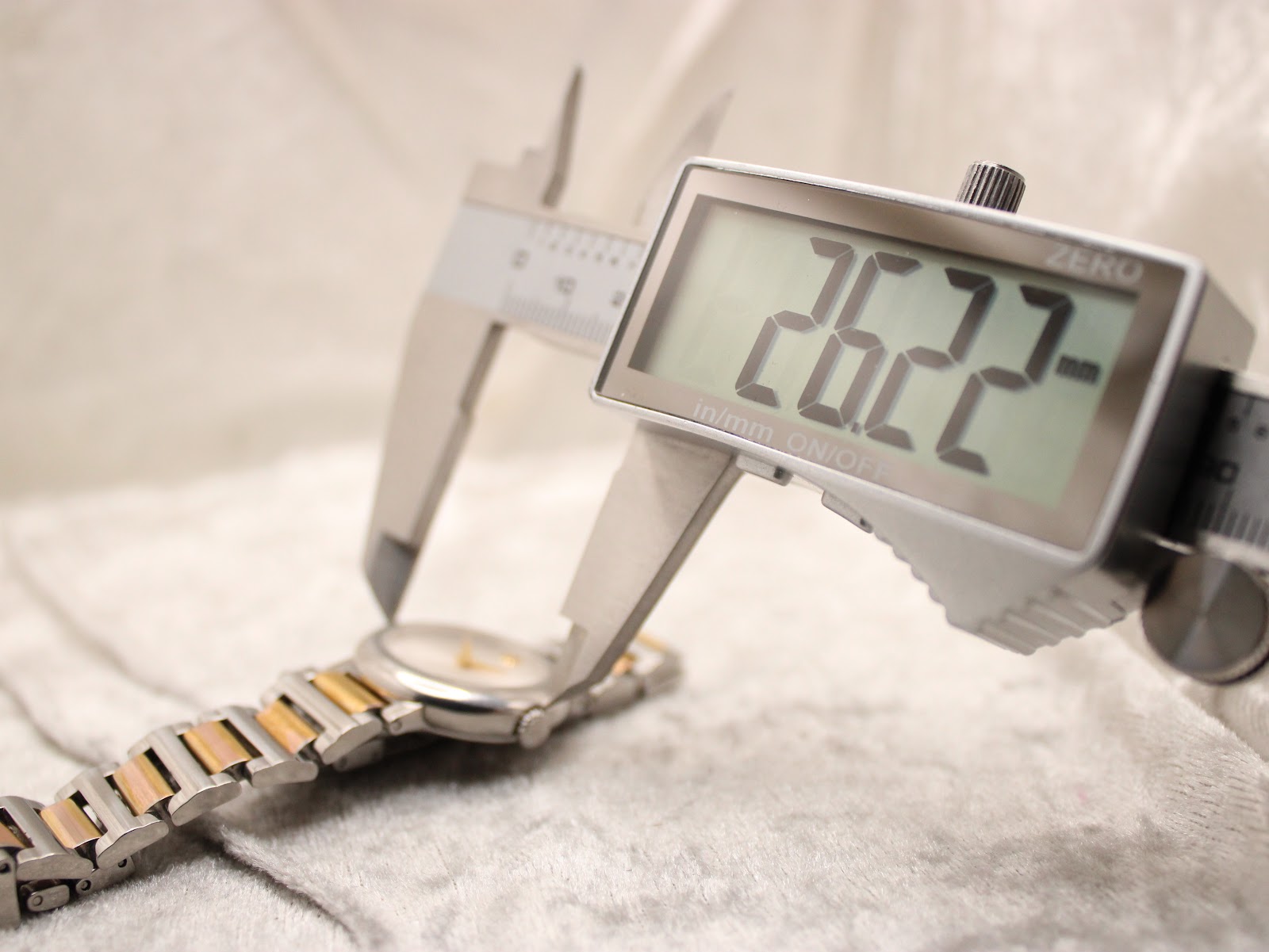Digital caliper measuring the case diameter of the Movado Concerto, displaying 26.22mm.