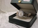 Movado Concerto watch resting inside its original dark green presentation box with gold crown detail.
