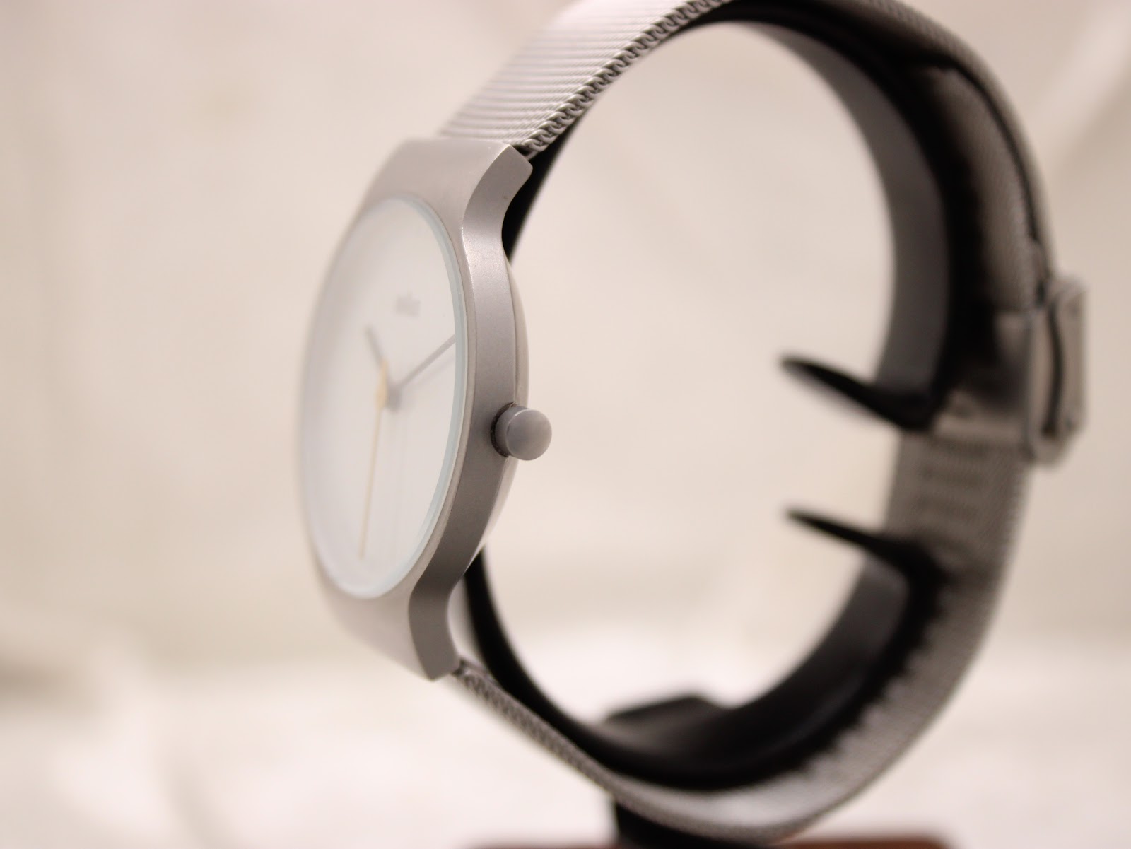Side profile of the Braun BN0211 watch showing its slim case design and matte grey finish, with the push-pull crown visible.