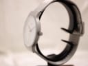 Side profile of the Braun BN0211 watch showing its slim case design and matte grey finish, with the push-pull crown visible.