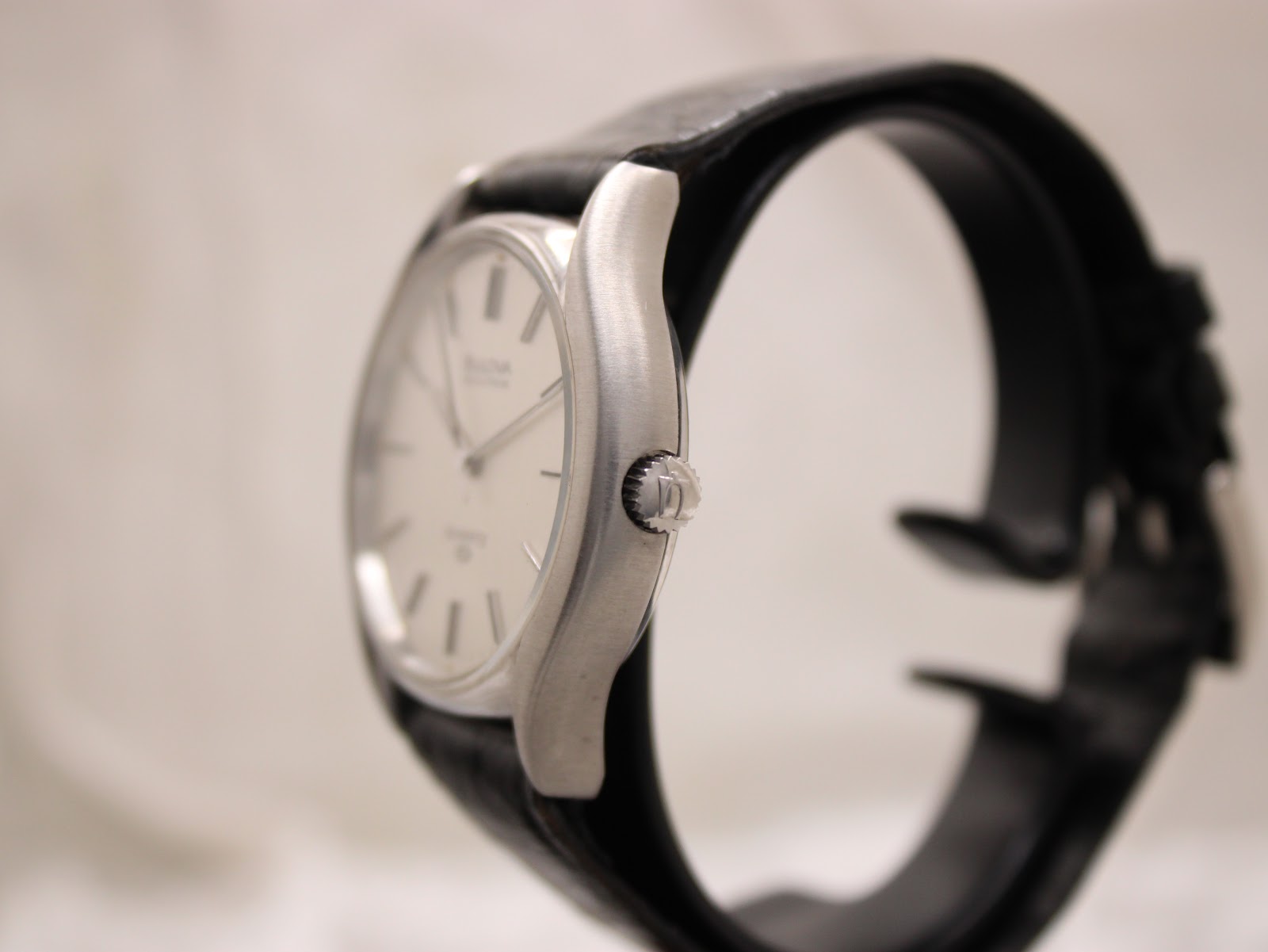 Side profile view of the Bulova Accutron watch case and crown, showing the brushed finish.