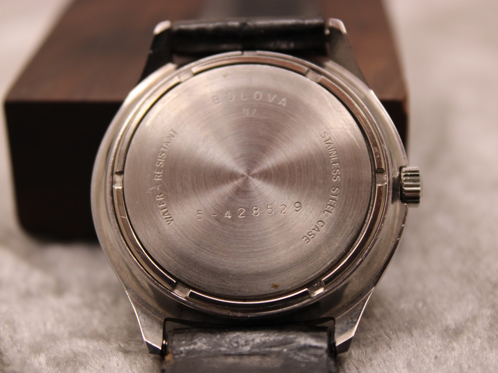 Close-up of the stainless steel case back with 'Bulova', 'Water-Resistant', 'Stainless Steel Case' and serial number '5-428529' engravings.