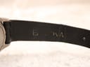 Close-up of the black leather strap, revealing the embossed 'Bulova' signature on its inner lining.