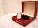 Bulova Accutron watch resting within its open original red presentation box with gold lettering.