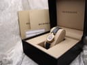 Burberrys watch presented in its original dark brown box with beige interior, alongside booklets.