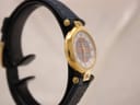 Angled view of the Burberrys watch highlighting the gold-tone case and blue strap.