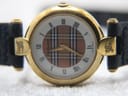 Detailed front view of the Burberrys check dial with Roman numerals and "Burberrys Swiss Made" text.