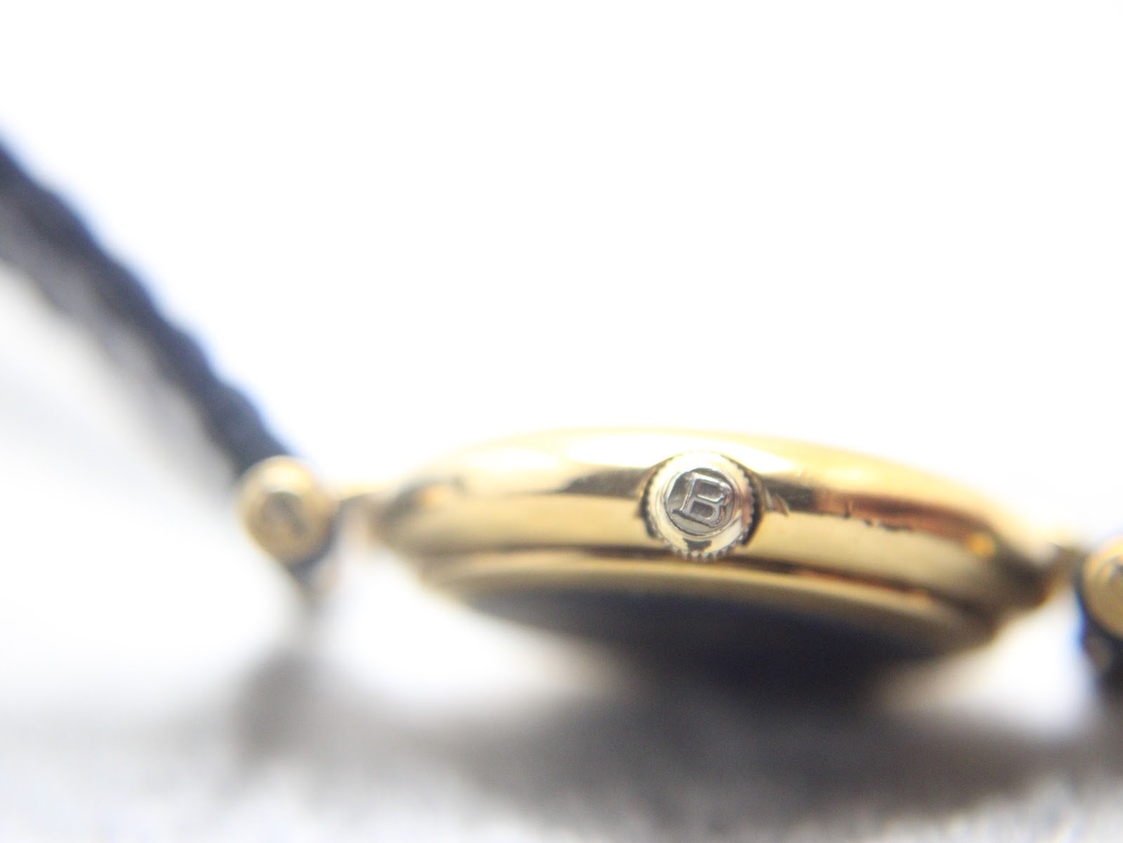 Close-up of the watch crown, signed with the Burberrys "B" logo.