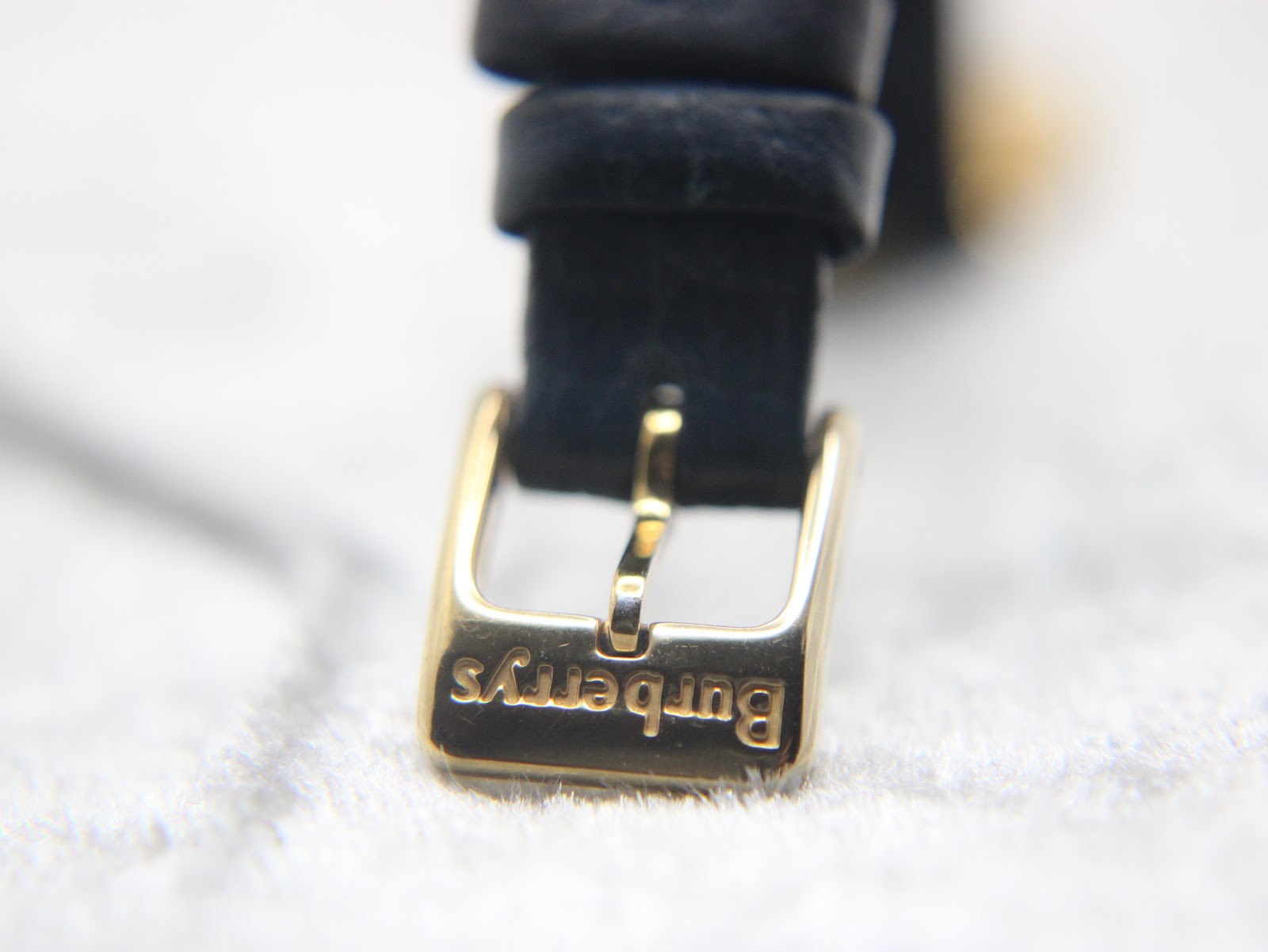 Close-up of the gold-tone buckle, signed with "Burberrys".