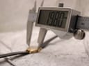 Digital caliper measuring the case diameter of the Longines Présence watch, showing an exact reading of "19.80 mm".