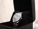 Angled view of the Oris Executive Crystal watch nestled in a black display box cushion.