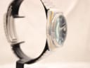 Opposite side profile of the watch case, showing the integrated bracelet connection and bezel edge wear.
