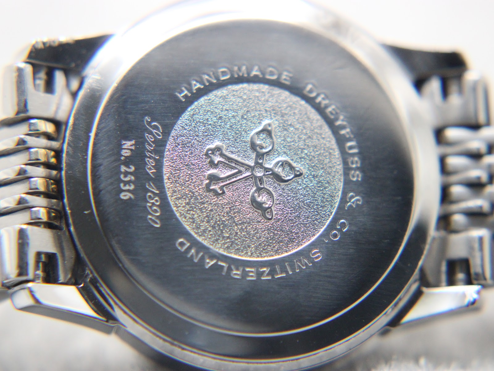 Close-up of the watch's stainless steel case back, featuring the Dreyfuss & Co logo and 'Series 1890 No. 2536' engraving.