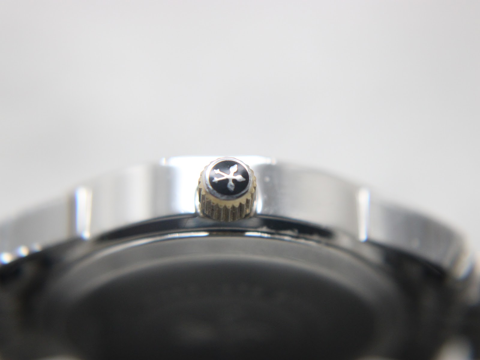 Detailed close-up of the gold-toned watch crown, showing the engraved Dreyfuss & Co emblem.