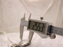 Digital caliper measuring the watch case diameter, displaying a precise reading of 25.53mm.