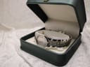 The Dreyfuss & Co watch nestled inside an open green presentation box, resting on a soft white surface.