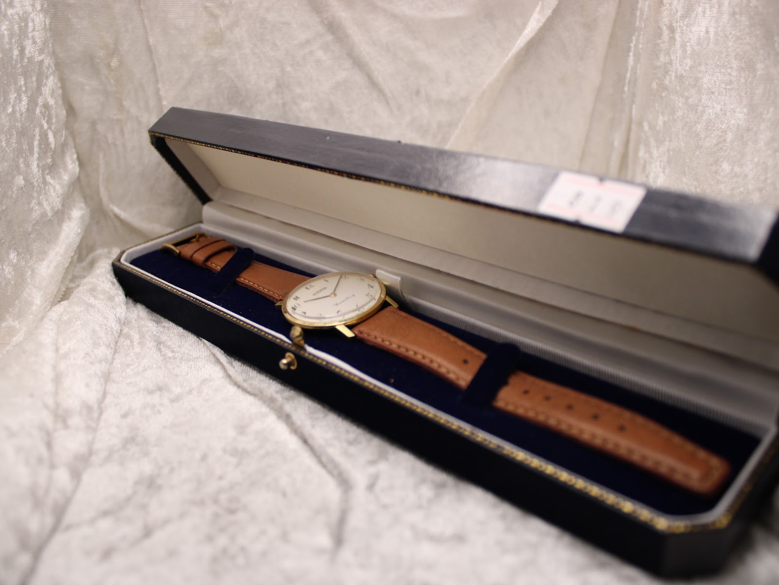 The Roamer Canterbury watch nestled inside a dark blue presentation box with a light blue interior lining.