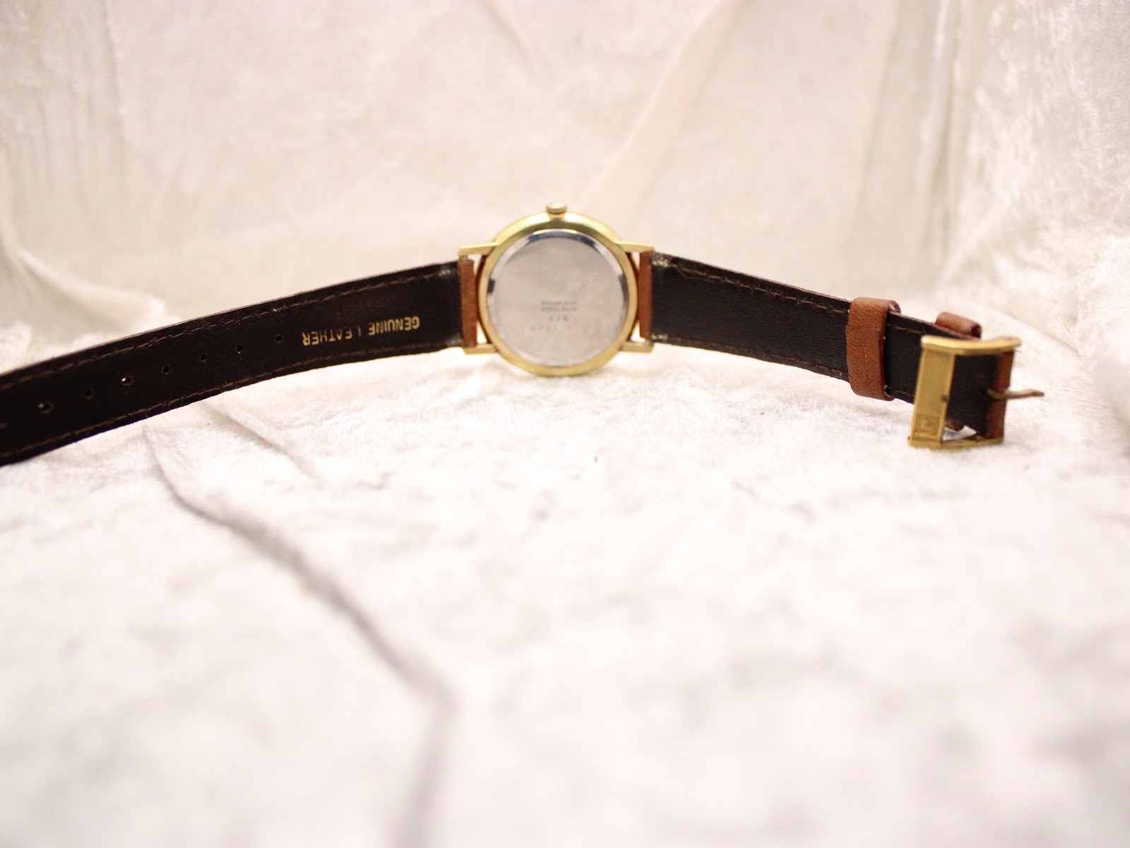 Full back view of the Roamer Canterbury watch, showing the case back and the full length of the light brown leather strap with its gold-tone buckle.