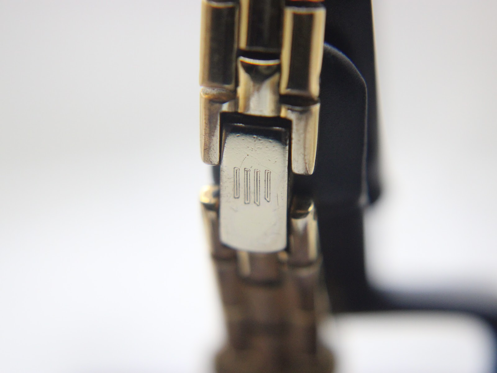 Close-up of the two-tone bracelet's fold-over clasp, showing the engraved Michel Herbelin logo.