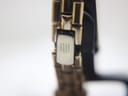 Close-up of the two-tone bracelet's fold-over clasp, showing the engraved Michel Herbelin logo.