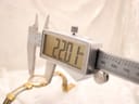 Digital caliper measuring the case diameter of the watch, displaying a reading of 22.01mm.