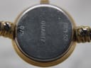 Close-up of the watch's case back, engraved with "QUARTZ", "0121-53", and "075".