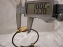 Digital caliper measuring the watch case diameter, showing a precise reading of 19.96mm.